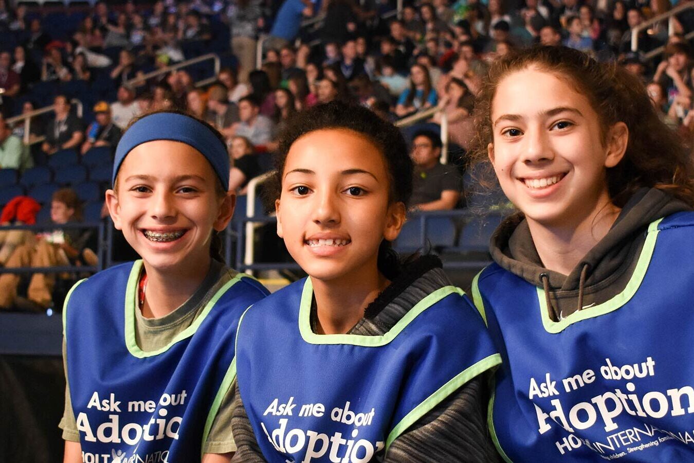 children volunteer with Holt sitting at a concert