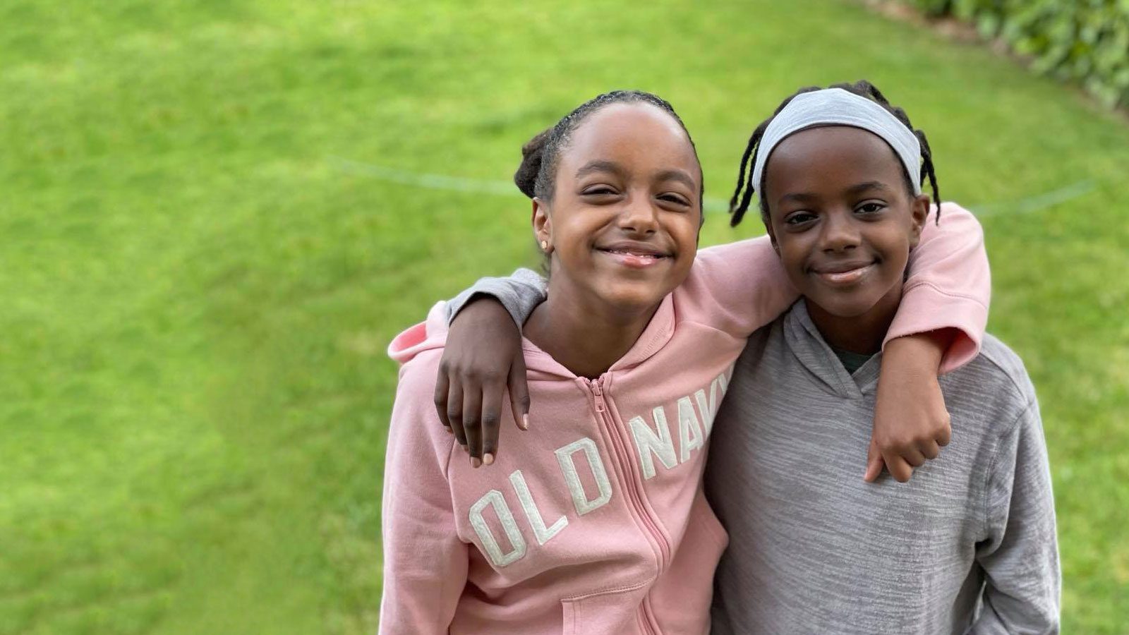 two female youth adoptees from Ethiopia with arms around each other