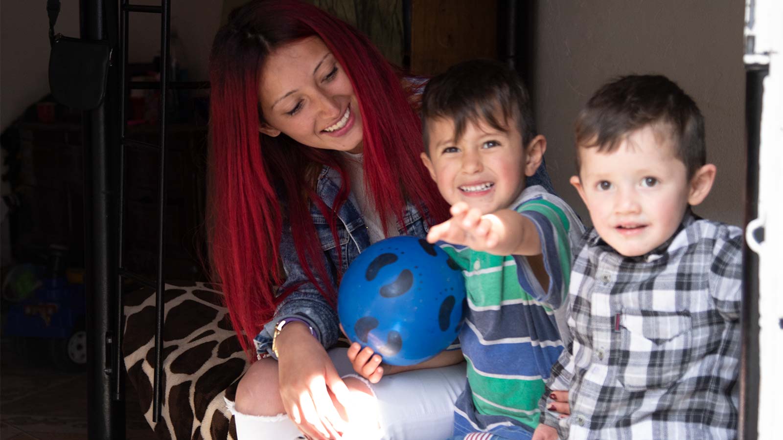 Girl smiling with two boys