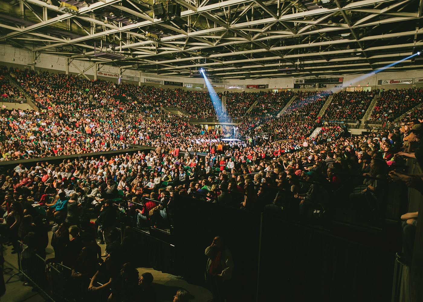 Audience looking at man on stage at a concert