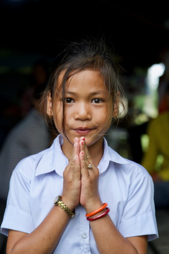 Sreyka holds her hands in a prayer gesture as she says thank you to her sponsor. 