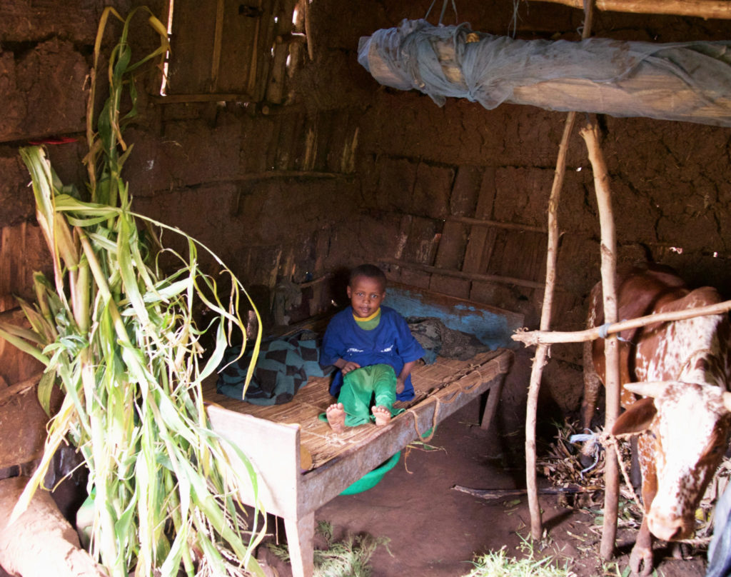 In Ethiopia, it's not uncommon for children to have just one pair of clothing. This boy puts on his one pair of pants because his family has visitors. 