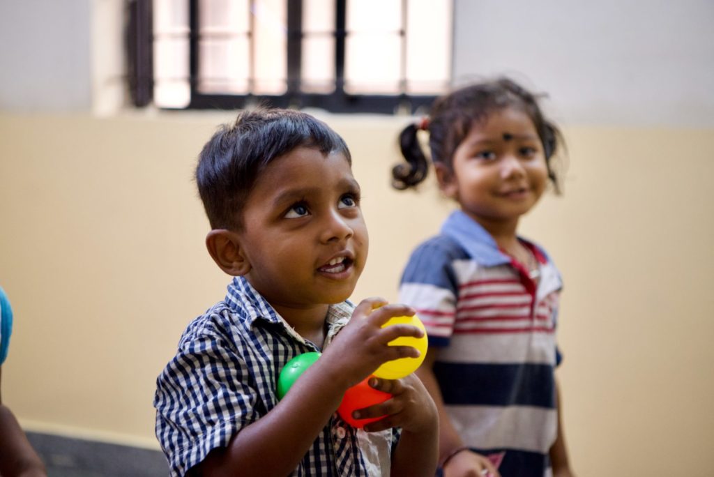 child in India plays at daycare