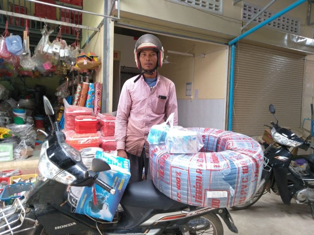 man standing with water pump and generator