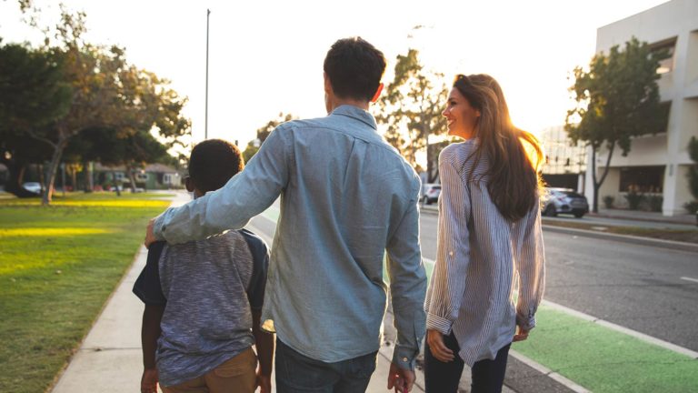 Family walking down sidewalk