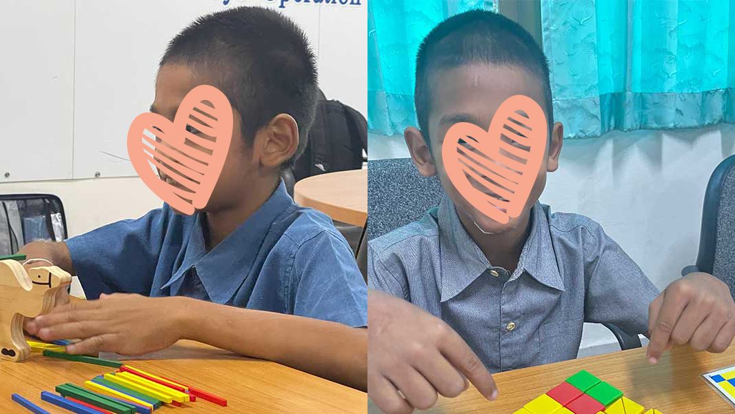 Little boy in blue shirt plays with toys at table