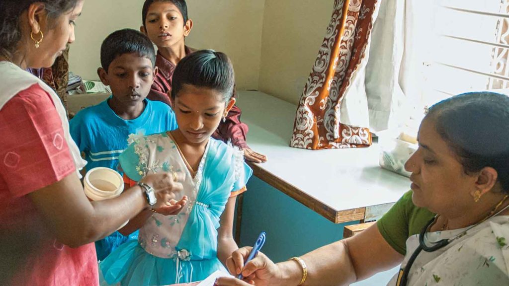 children in line to receive parasite medication