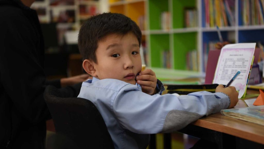 boy writing in notebook