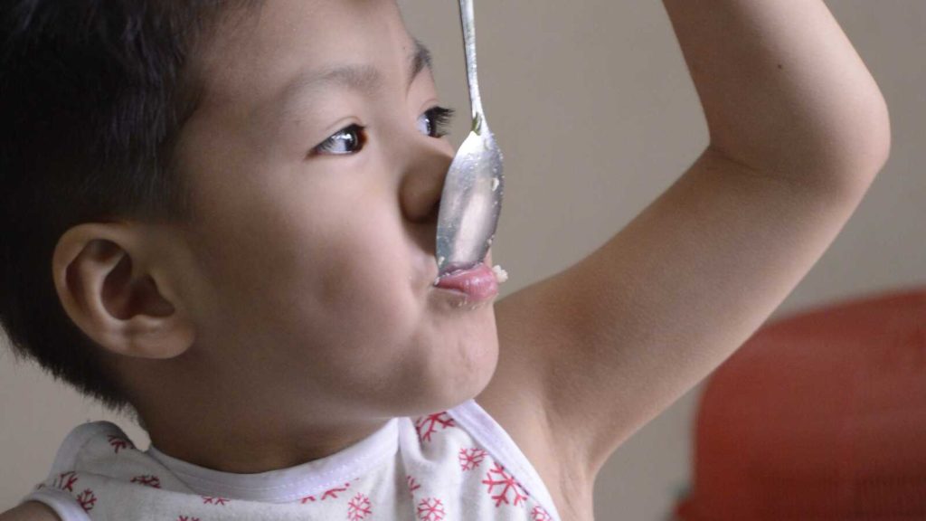 child eating from spoon