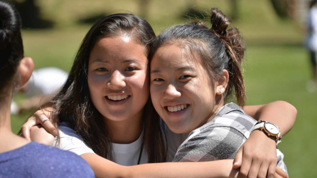 two adopted girls smile for camera