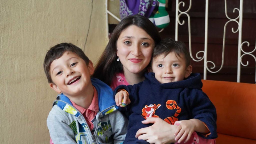 mother smiling with two boys