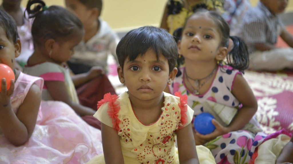 toddlers in India playing on the floor