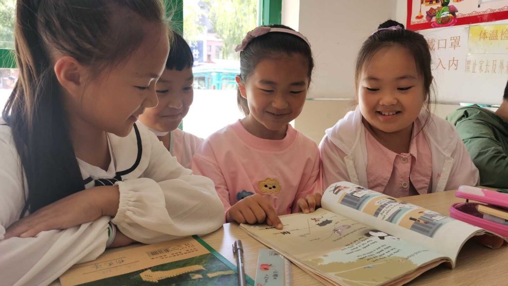 girls reading from book